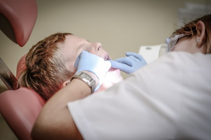 Dentist checking a boy's teeth